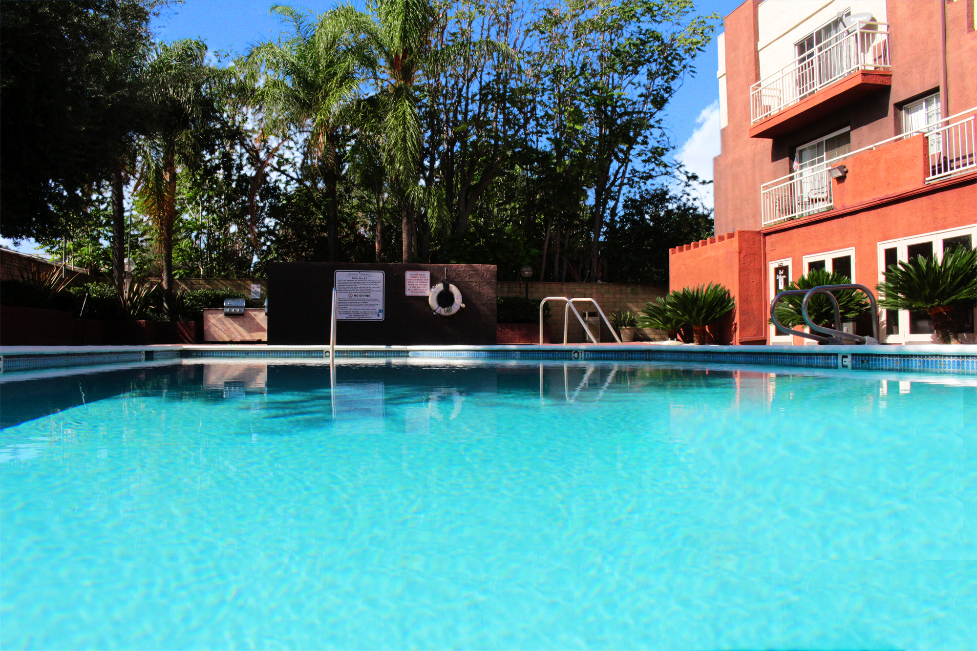 This banner image shows the swimming pool of Sunset Terrace Apartment Homes.